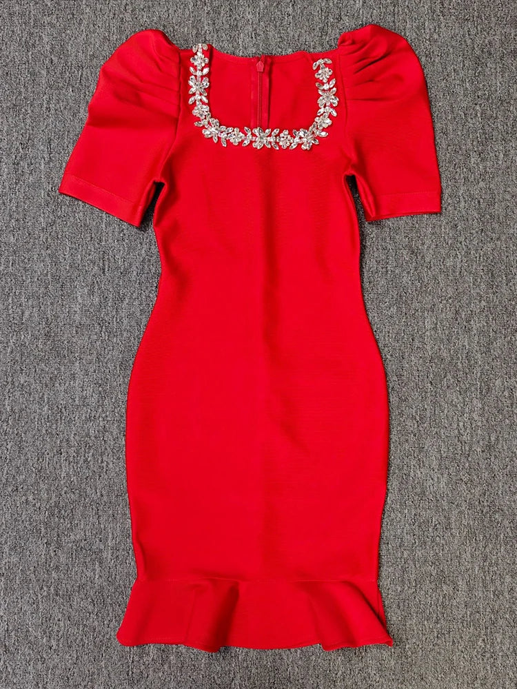 Red dress with embellished neckline on a gray background