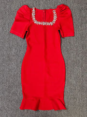 Red dress with embellished neckline on a gray background