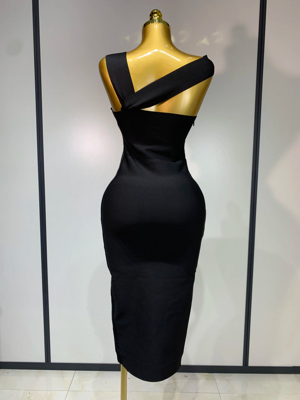 Black strapless sheath midi dress with hollow out detail.