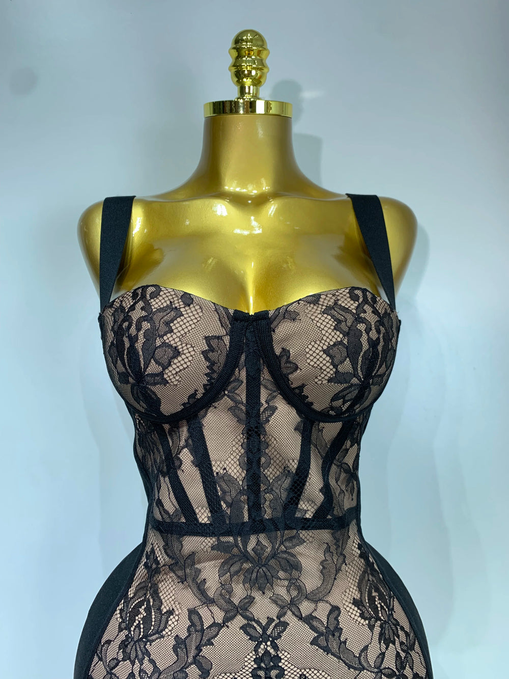 Close-up of sleeveless V-neck lace overlay bodycon midi dress neckline