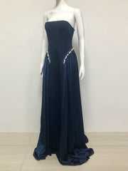 Navy strapless gown with embellishments on a mannequin against a white background