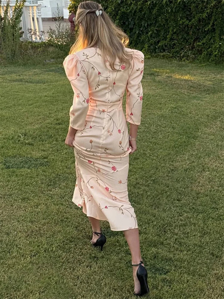 Woman wearing a floral dress standing on grass