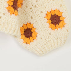 Close-up of a crocheted square with sunflower patterns
