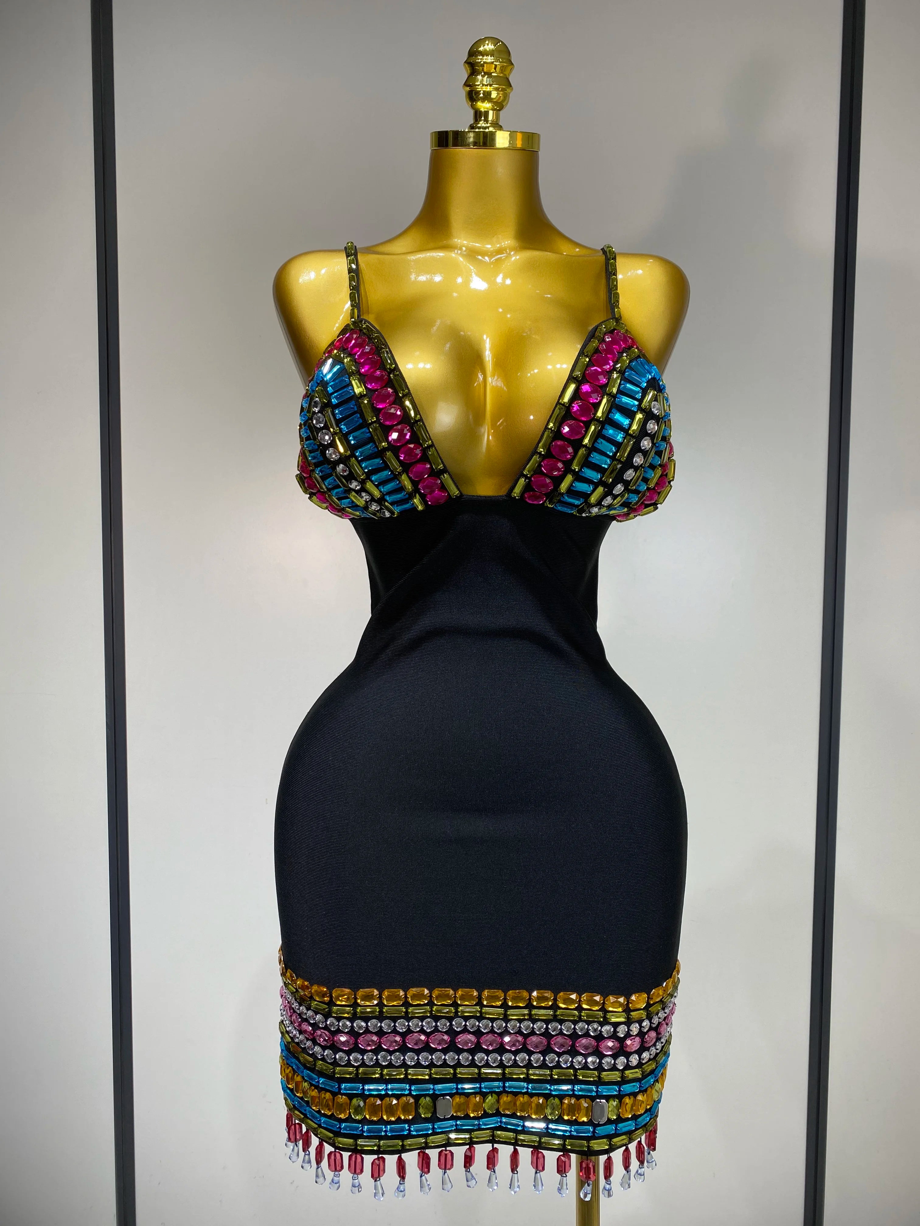 Black dress with colorful beaded top on a mannequin against a neutral background