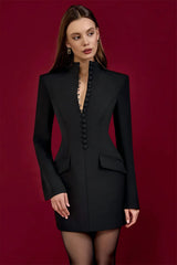 Woman wearing a black blazer dress against a red background