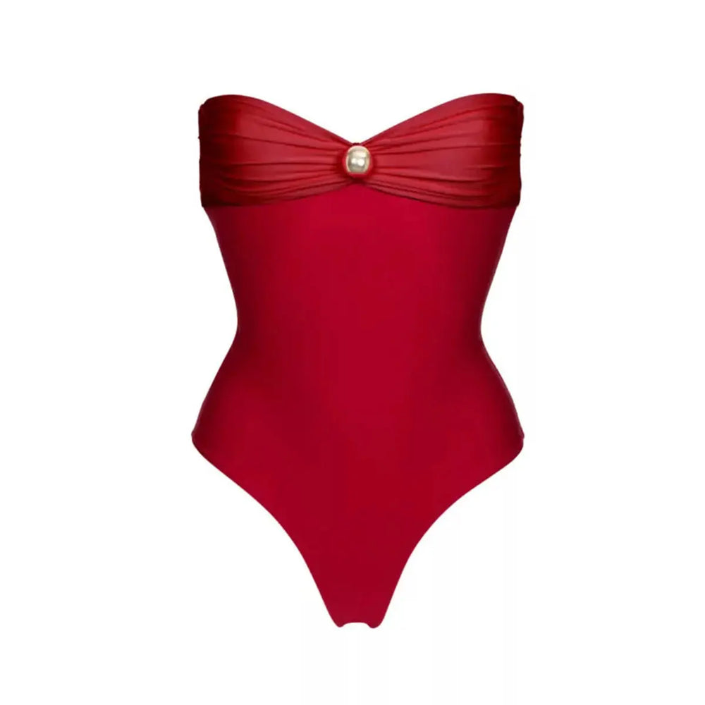 Close-up of a red bandeau swimsuit with a single pearl accent