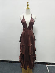 Brown tiered dress on a mannequin against a white wall.