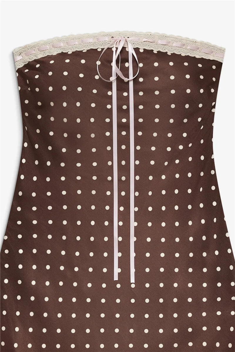 Brown strapless top with white polka dots and lace trim on a white background