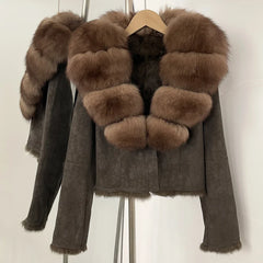 Brown suede jacket with fur trim on a hanger against a white background