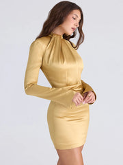 Woman wearing a gold dress against a white background