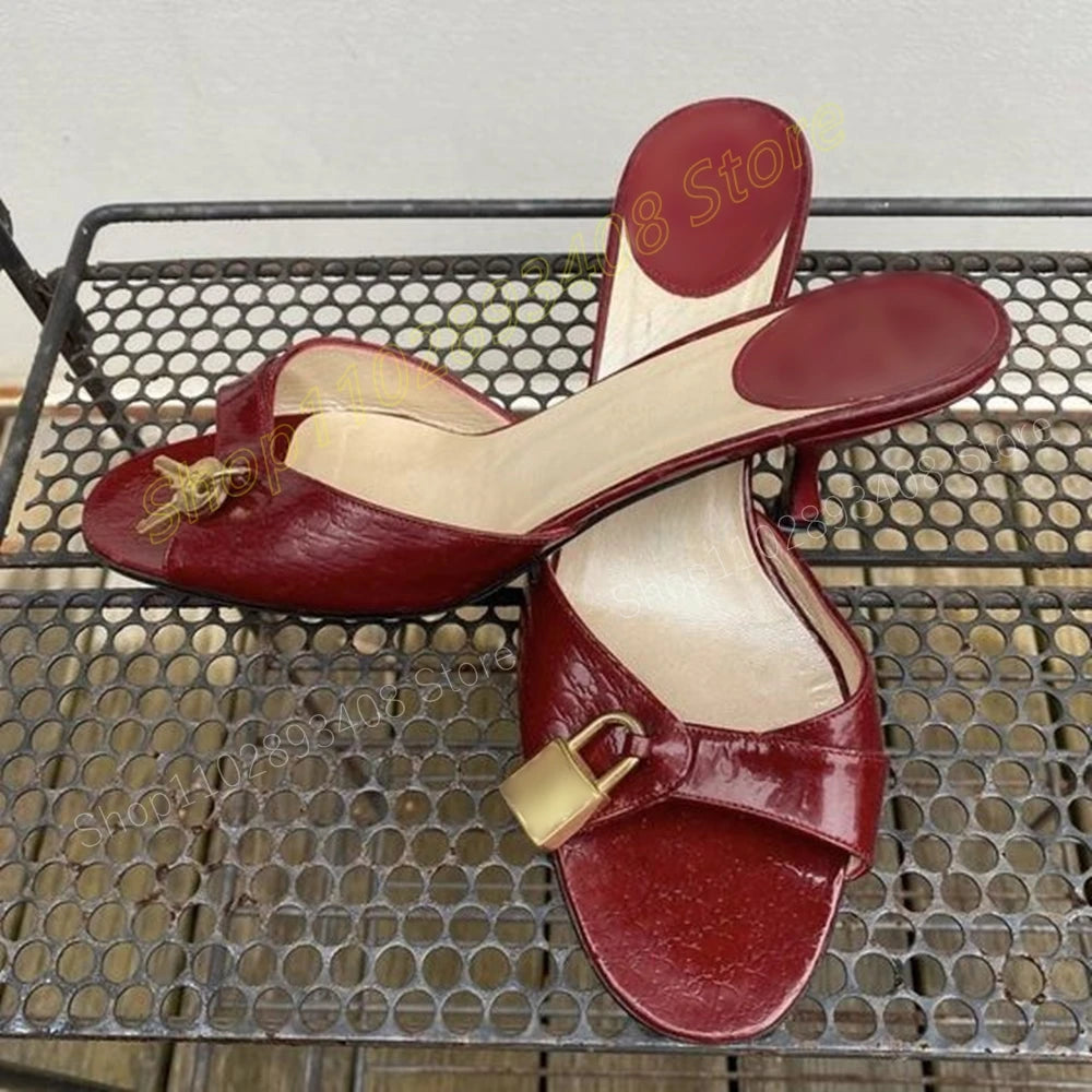 Red peep toe stiletto heels with a lock and key detail.