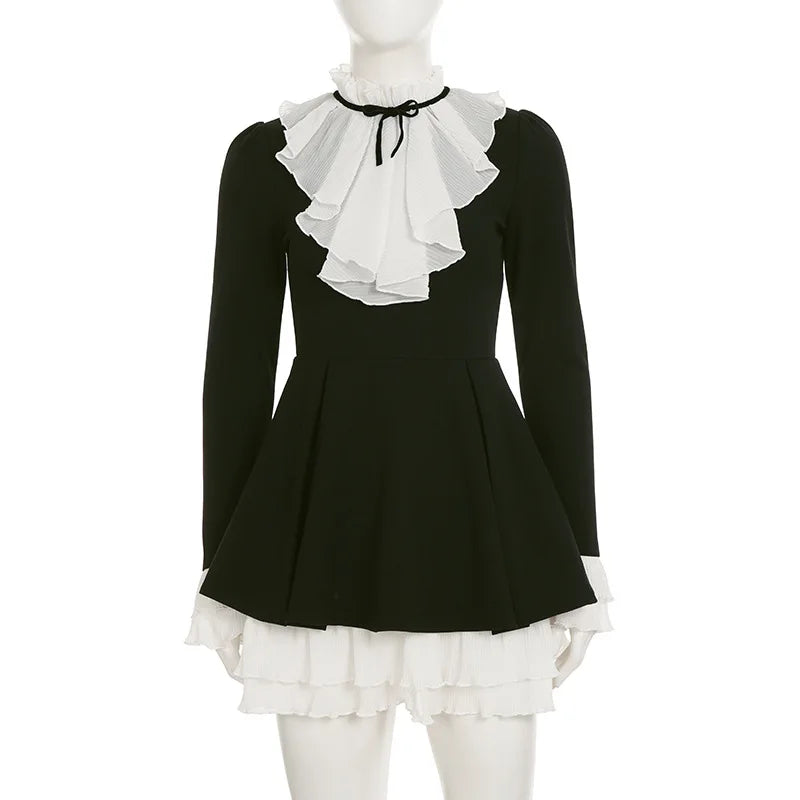 Black dress with white ruffled collar and hem on a mannequin against a white background