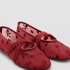 Close-up of red embroidered mesh ballet flats