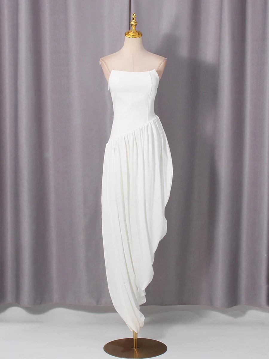 White strapless dress on a mannequin against a gray curtain background