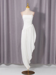 White strapless dress on a mannequin against a gray curtain background