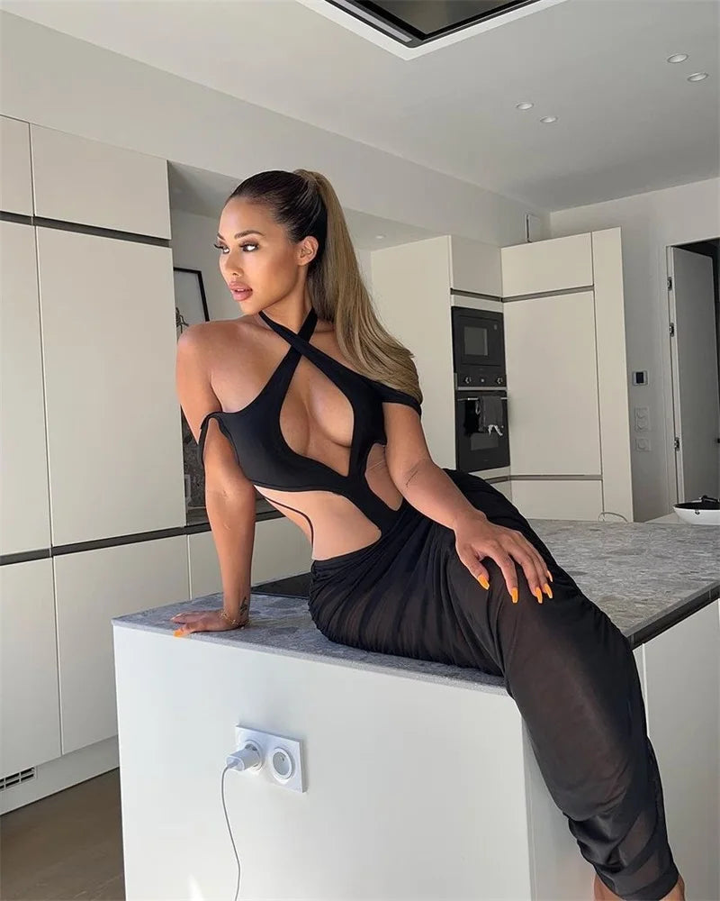 Woman in a black outfit sitting on a kitchen counter