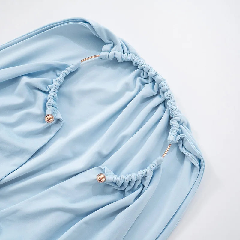 Light blue fabric with decorative buttons on a white background