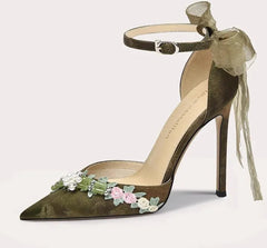 High-heeled shoe with floral decorations on a white background