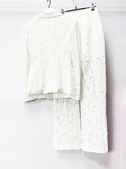 White lace outfit on a hanger against a white background