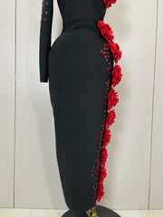 Black dress with red floral details on a mannequin against a white background