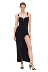 Black dress with a high slit worn by a model on a white background