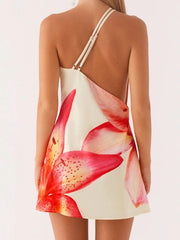 Woman wearing a dress with floral design on a plain background