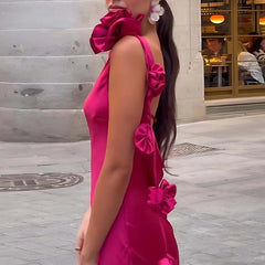 Woman wearing a pink dress with ruffled details in an urban setting