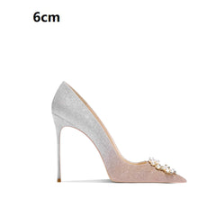 High-heeled shoe with decorative embellishments on a white background