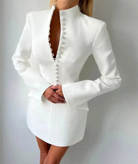 White dress with long sleeves on a plain background