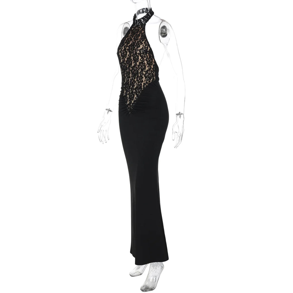 Black evening gown with gold lace detailing on a mannequin against a white background