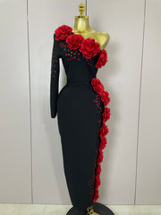 Black dress with red floral embellishments on a mannequin against a white background