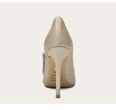 Beige high-heeled shoe with a stiletto heel on a white background