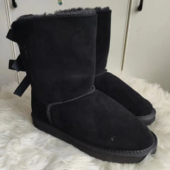 Black plush snow boots with ribbon bows