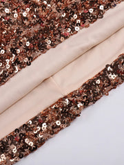Close-up of rose gold sequin trim on beige fabric
