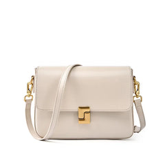 Beige handbag with gold clasp and chain strap on a white background