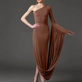 Brown one-shoulder dress with flowing fabric on a dark background