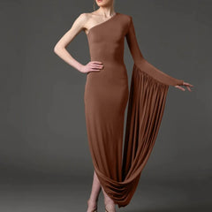 Brown one-shoulder dress with flowing fabric on a dark background