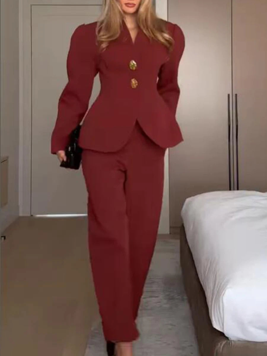 Person wearing a red suit in a room with neutral walls and a bed.
