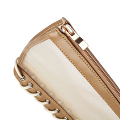 Close-up of a beige handbag with a gold zipper