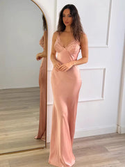 Satin maxi slipdress with V-neck lace trim and spaghetti straps in pink.