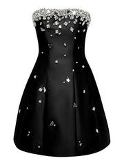 Black dress with silver embellishments on a white background