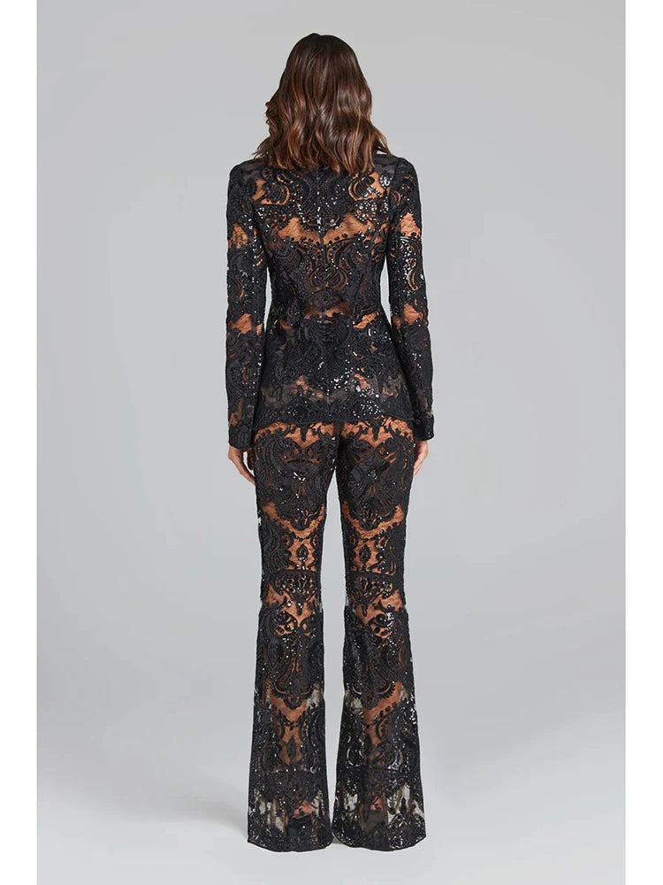 Rear view of the black sequin embroidered lace blazer and flare pants set.