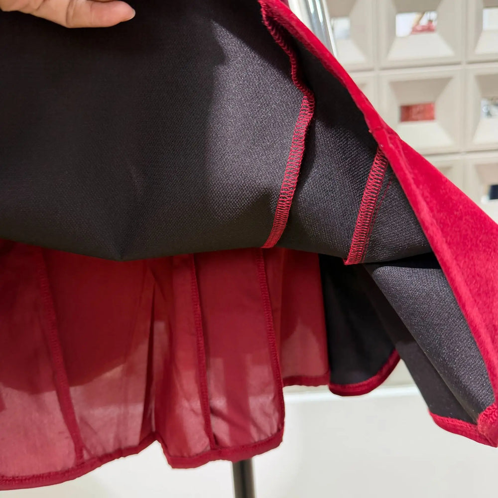 Close-up of a red and black fabric with a textured pattern.