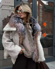 Person wearing a beige coat with fur trim in an urban setting