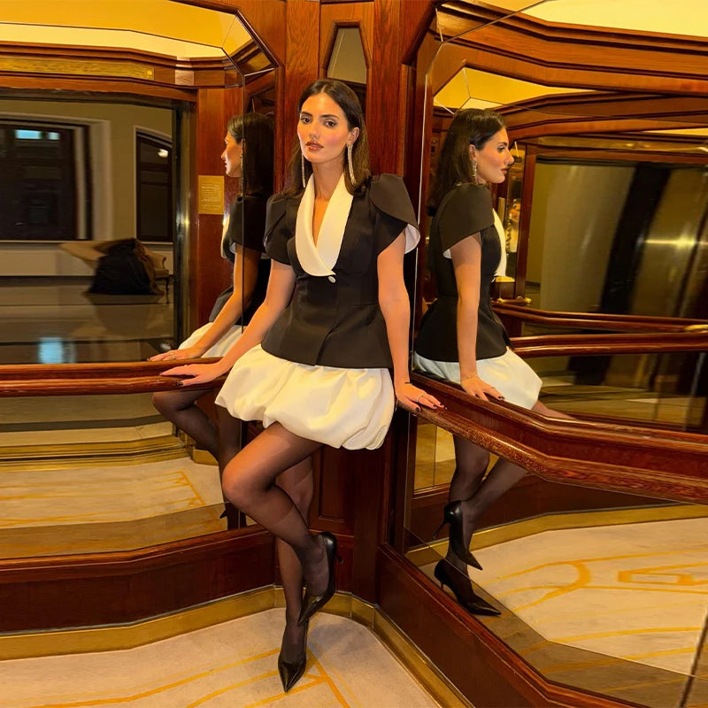 Two women in formal attire sitting in a luxurious train car.