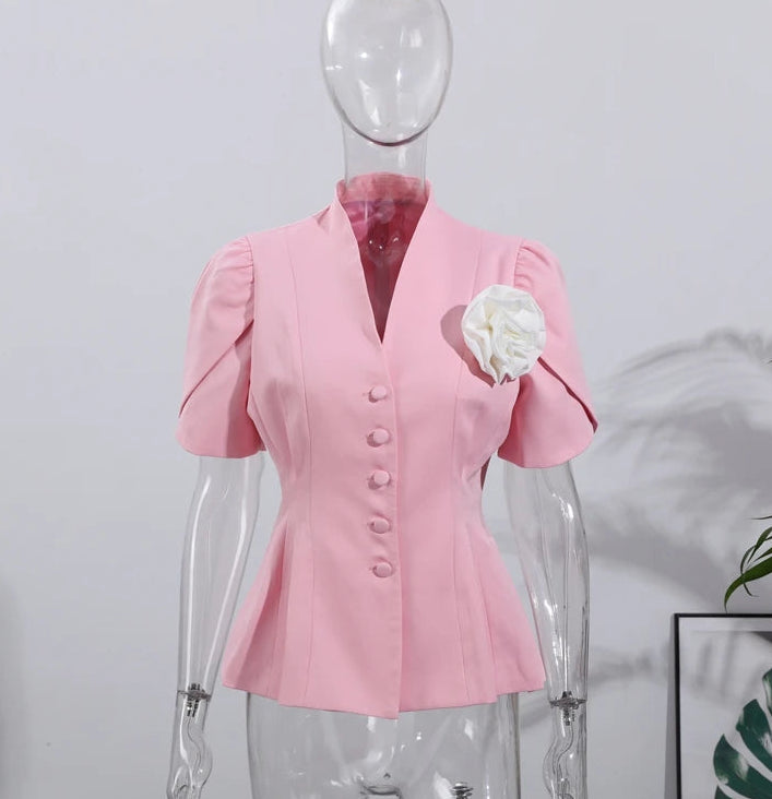 Pink blouse on a mannequin against a white background