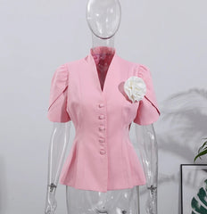 Pink blouse on a mannequin against a white background