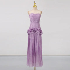 Purple evening gown on a mannequin against a plain background