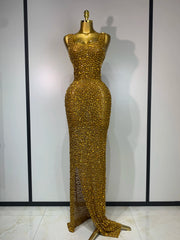 Gold diamond-embellished maxi dress on a mannequin
