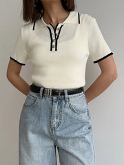 Model wearing white ribbed knit polo collar cropped top with light wash jeans